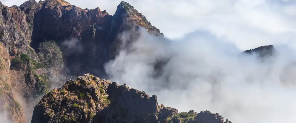 Rock ridge at Pico do Arieiro with cloud pouring around it